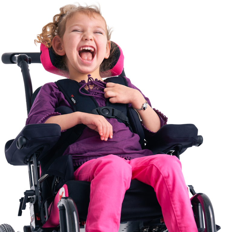 Girl in pink and black wheelchair laughs.