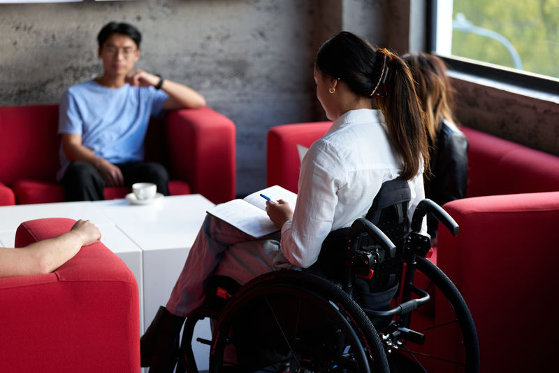 Chelsea sits easily in her wheelchair while conducting business.